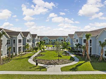 A row of houses with a garden in the foreground.